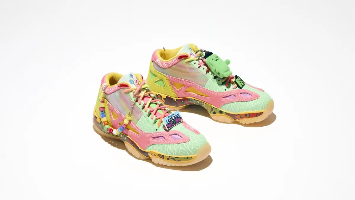 Green, pink and yellow Air Jordan 11 Low IE shoes with decorative charms, photographed by Nike for Doernbecher Freestyle 22.
